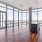 a room with a large window and a wood floor with a wood floor